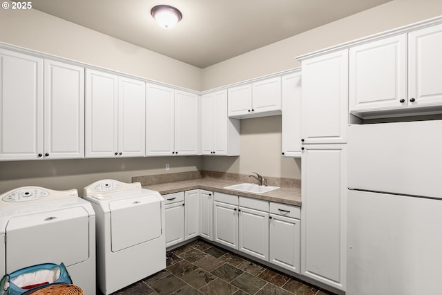 8585 NW Copeland St, Portland, OR 97229 - laundry area with cabinet space, independent washer and dryer, and stone finish flooring