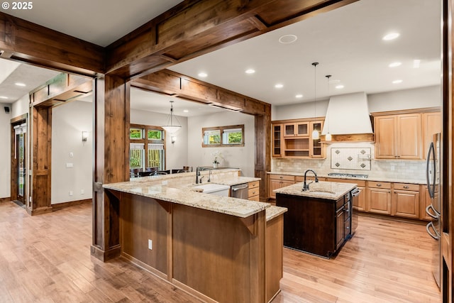 8585 NW Copeland St, Portland, OR 97229 - kitchen featuring a large island, premium range hood, a sink, recessed lighting, and light wood-style flooring