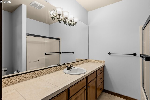 8585 NW Copeland St, Portland, OR 97229 - full bath with vanity, toilet, a shower with door, tile patterned flooring, and baseboards