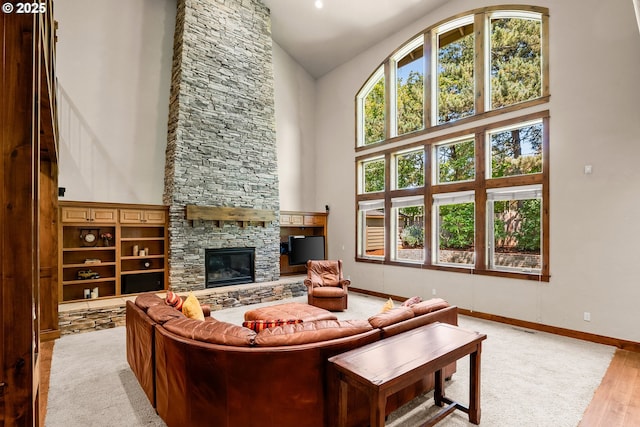 8585 NW Copeland St, Portland, OR 97229 - living area with high vaulted ceiling, a fireplace, and baseboards