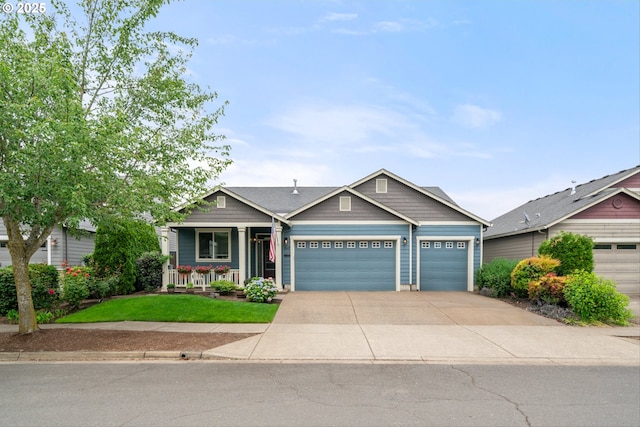 2637 Baines Blvd, Hubbard, OR 97032 - craftsman-style home with an attached garage, covered porch, concrete driveway, and a front lawn