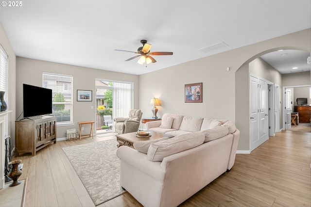 2637 Baines Blvd, Hubbard, OR 97032 - living area with arched walkways, ceiling fan, and light wood-style flooring
