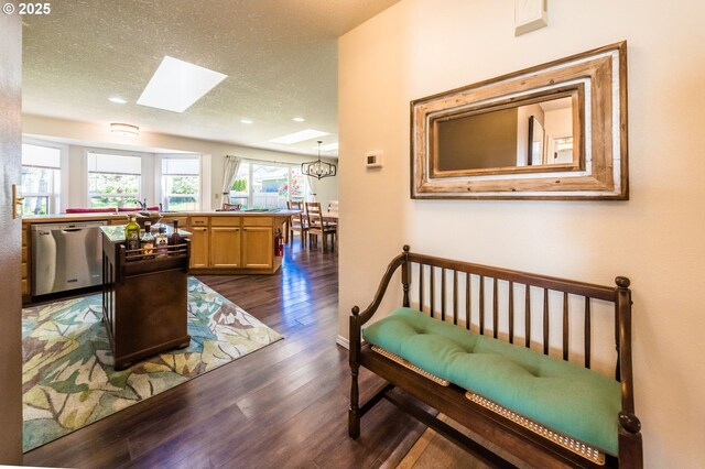 105 Sijota St, Gleneden Beach, OR 97388 - interior space featuring an inviting chandelier, a skylight, a textured ceiling, dark wood-type flooring, and recessed lighting