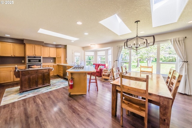 105 Sijota St, Gleneden Beach, OR 97388 - interior space featuring an inviting chandelier, recessed lighting, a skylight, a textured ceiling, and dark wood-style floors