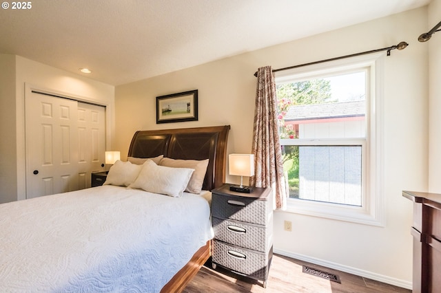 105 Sijota St, Gleneden Beach, OR 97388 - bedroom featuring a closet, wood finished floors, visible vents, recessed lighting, and baseboards