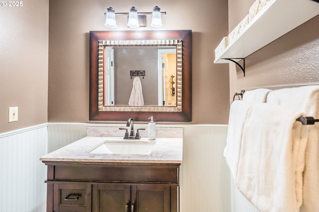 105 Sijota St, Gleneden Beach, OR 97388 - bathroom with vanity, a wainscoted wall, and a textured wall