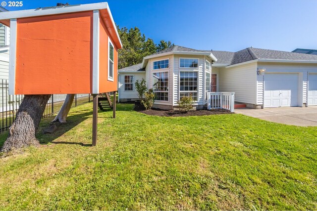 105 Sijota St, Gleneden Beach, OR 97388 - rear view of house with a yard, roof with shingles, a garage, and fence
