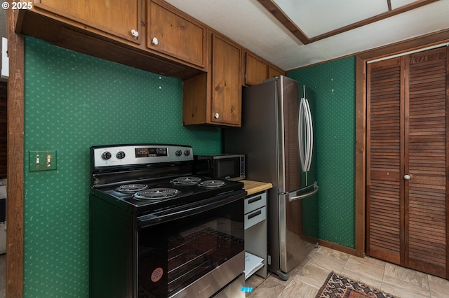 kitchen with brown cabinetry and stainless steel appliances