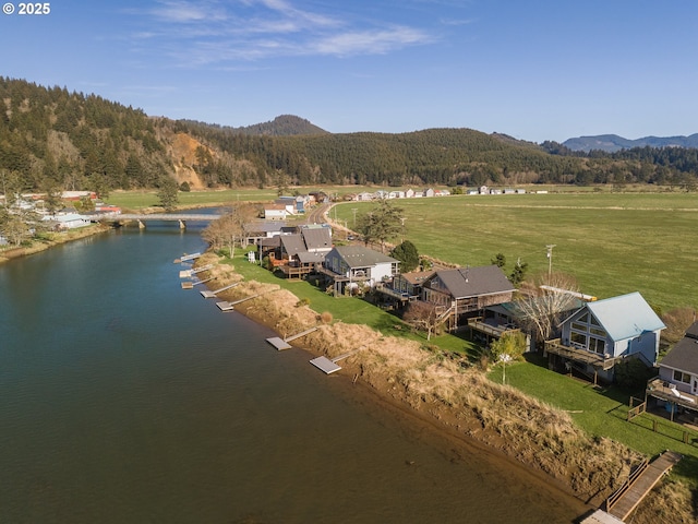 drone / aerial view featuring a water and mountain view