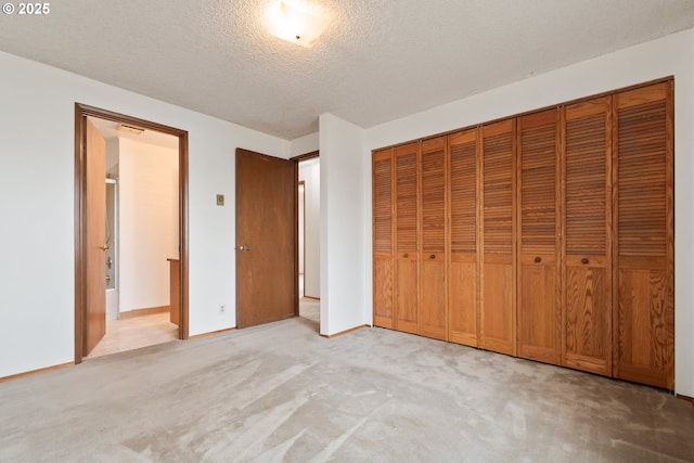 unfurnished bedroom featuring light carpet, visible vents, baseboards, a textured ceiling, and a closet