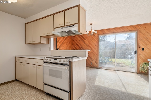 kitchen with cream cabinetry, light countertops, range with electric stovetop, and under cabinet range hood