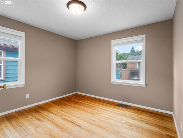 4501 NW Washington St, Vancouver, WA 98663 - spare room with baseboards, light wood-type flooring, and a textured ceiling