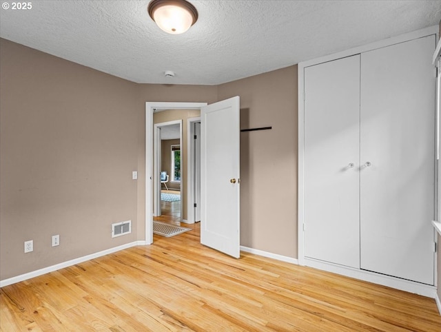 4501 NW Washington St, Vancouver, WA 98663 - unfurnished bedroom with baseboards, light wood finished floors, a textured ceiling, and a closet