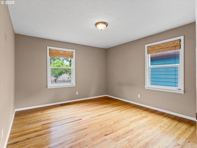4501 NW Washington St, Vancouver, WA 98663 - unfurnished room featuring wood finished floors, baseboards, and a textured ceiling