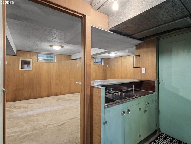 4501 NW Washington St, Vancouver, WA 98663 - kitchen featuring a sink, dark countertops, wooden walls, and a textured ceiling