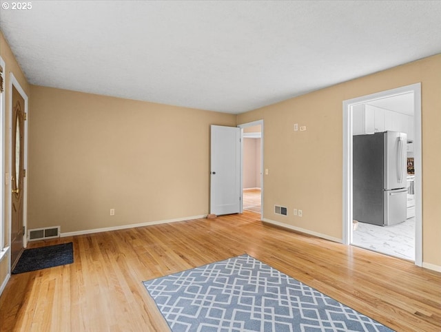4501 NW Washington St, Vancouver, WA 98663 - unfurnished bedroom with freestanding refrigerator, wood finished floors, baseboards, and ensuite bath