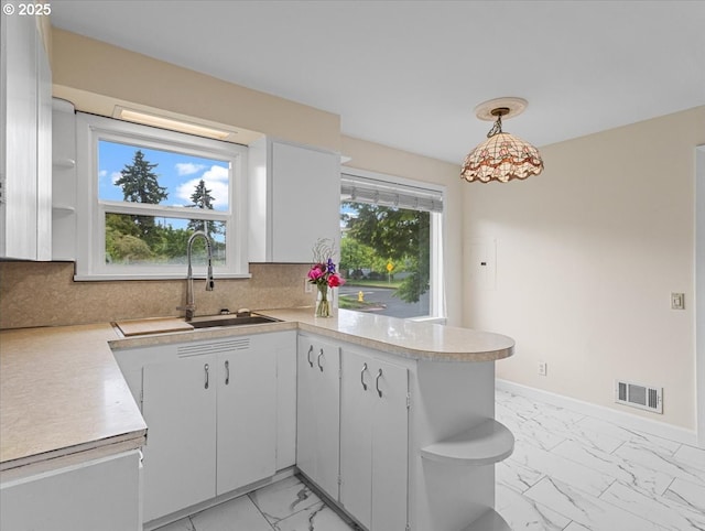 4501 NW Washington St, Vancouver, WA 98663 - kitchen with light marble finish flooring, light countertops, open shelves, and a sink