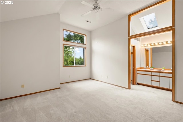 5002 SW Vacuna St, Portland, OR 97219 - unfurnished bedroom with vaulted ceiling, carpet floors, a skylight, and baseboards