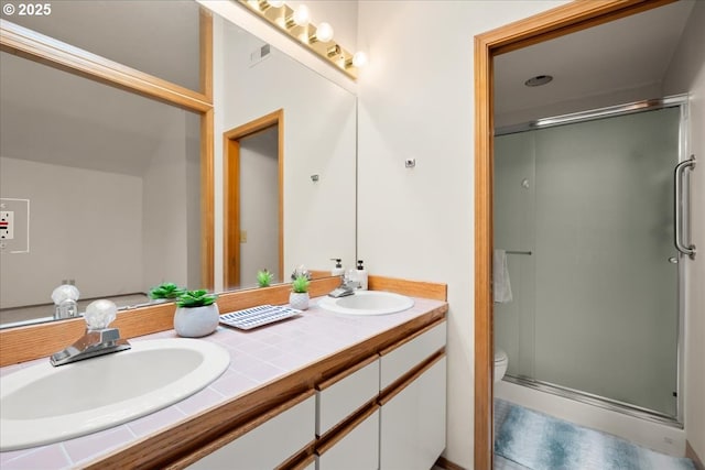 5002 SW Vacuna St, Portland, OR 97219 - bathroom featuring a stall shower, double vanity, and toilet