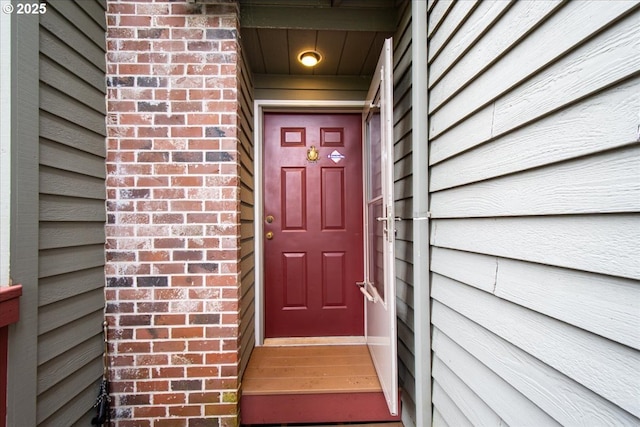 5002 SW Vacuna St, Portland, OR 97219 - doorway to property featuring brick siding