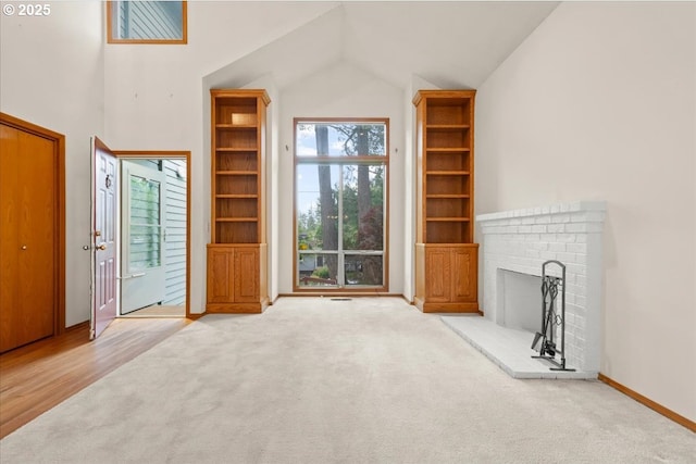 5002 SW Vacuna St, Portland, OR 97219 - unfurnished living room featuring carpet flooring, vaulted ceiling, a fireplace, and baseboards