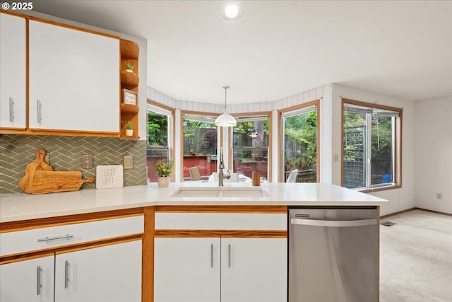 5002 SW Vacuna St, Portland, OR 97219 - kitchen featuring dishwasher, a peninsula, white cabinets, a sink, and healthy amount of natural light