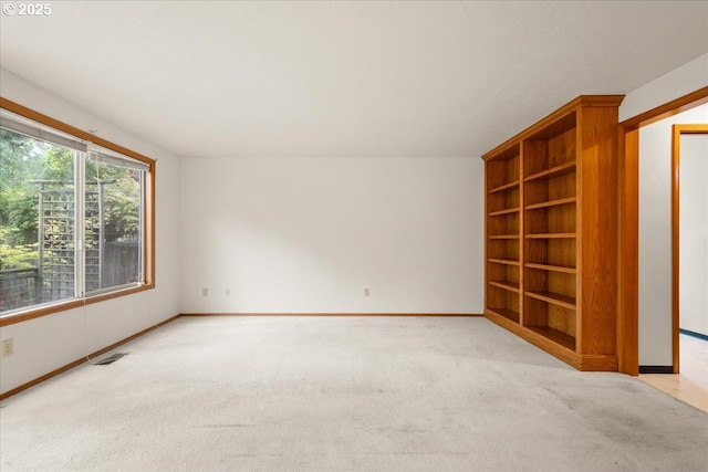 5002 SW Vacuna St, Portland, OR 97219 - empty room with baseboards, light carpet, and built in shelves