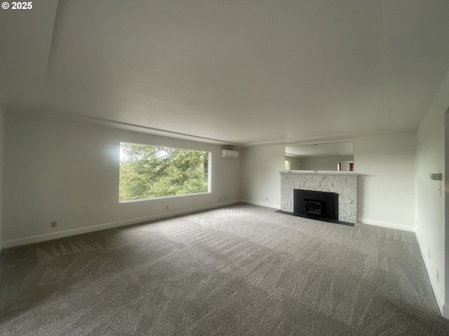 unfurnished living room featuring carpet flooring, baseboards, a wall mounted AC, and a brick fireplace