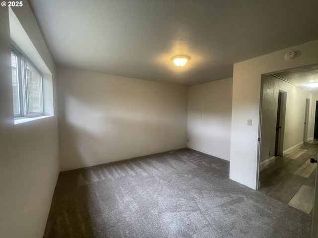 empty room featuring carpet flooring and a smoke detector
