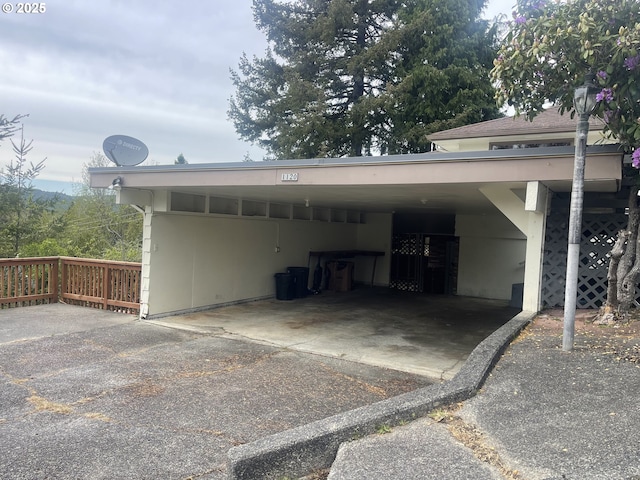 view of parking / parking lot with driveway and a carport