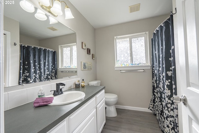 bathroom featuring vanity, toilet, a chandelier, and hardwood / wood-style floors