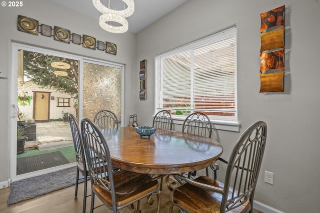 dining room featuring a notable chandelier and hardwood / wood-style flooring