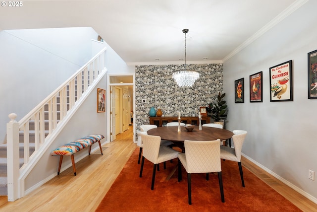 dining room with stairs, ornamental molding, and wood finished floors