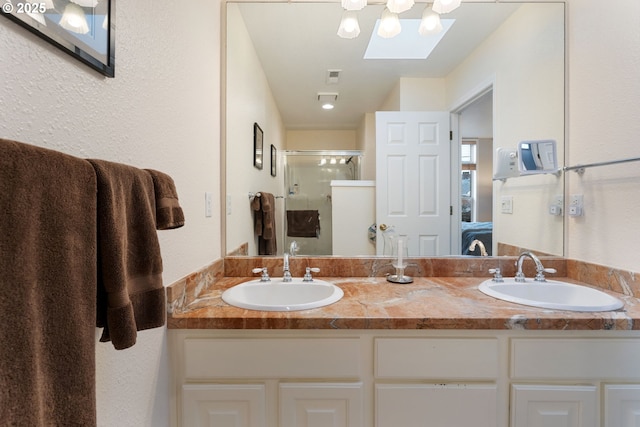 full bath featuring double vanity, ensuite bath, a sink, and a stall shower