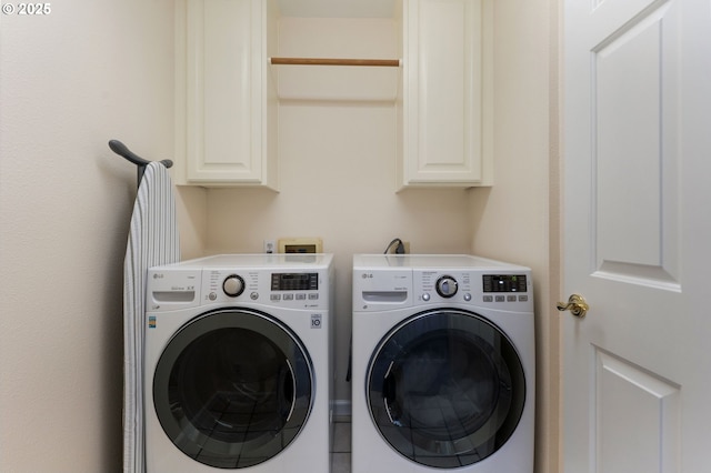 clothes washing area with cabinet space and washing machine and dryer