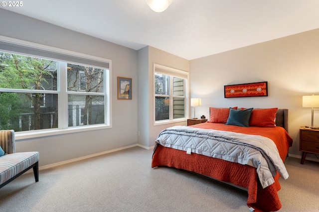 carpeted bedroom with multiple windows and baseboards