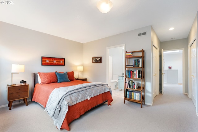 bedroom featuring carpet, connected bathroom, visible vents, and baseboards