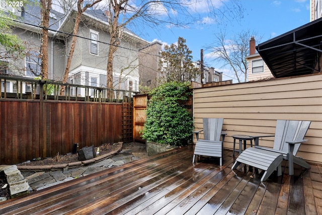 wooden terrace featuring a fenced backyard