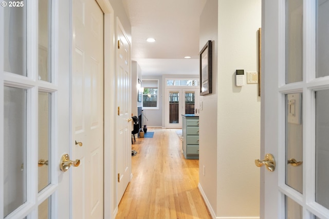 corridor with recessed lighting, baseboards, and light wood finished floors