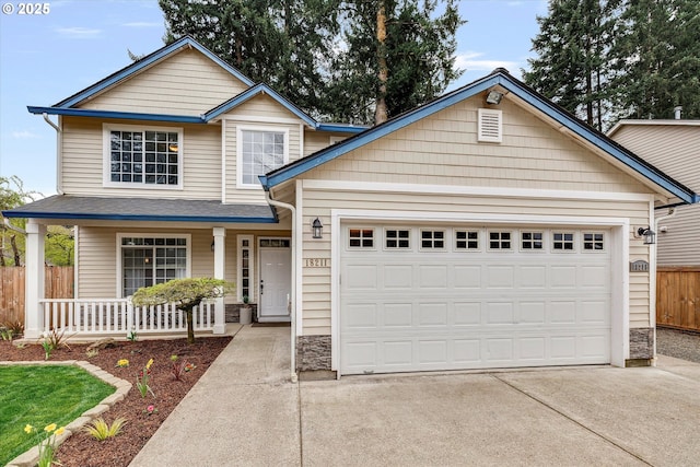 18211 NE 32nd St, Vancouver, WA 98682 - view of front facade with covered porch, stone siding, fence, an attached garage, and driveway