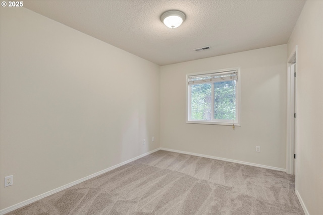 18211 NE 32nd St, Vancouver, WA 98682 - spare room featuring baseboards, visible vents, a textured ceiling, and light colored carpet