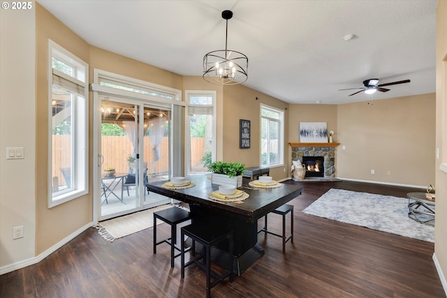 18211 NE 32nd St, Vancouver, WA 98682 - dining space with ceiling fan with notable chandelier, dark wood-style flooring, a fireplace, and baseboards