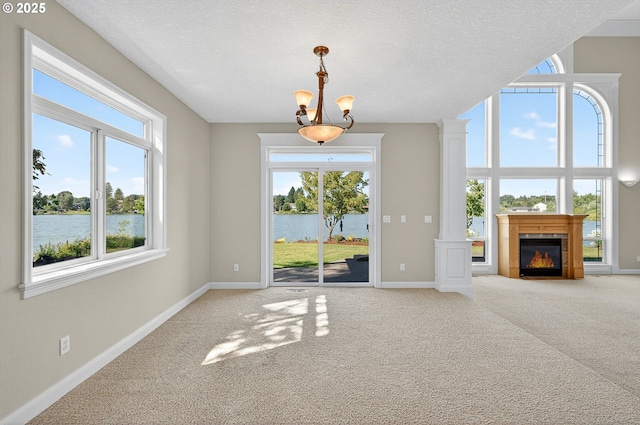 21401 NE Shore Dr, Fairview, OR 97024 - unfurnished living room with a water view, plenty of natural light, carpet flooring, and a textured ceiling
