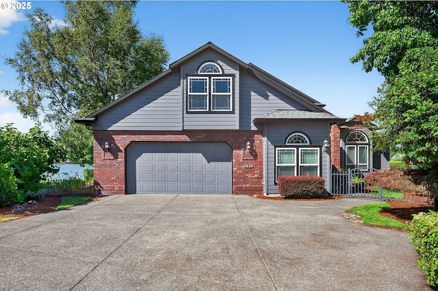 21401 NE Shore Dr, Fairview, OR 97024 - view of front of house with an attached garage, driveway, and brick siding