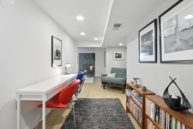 home office with light wood-type flooring and recessed lighting