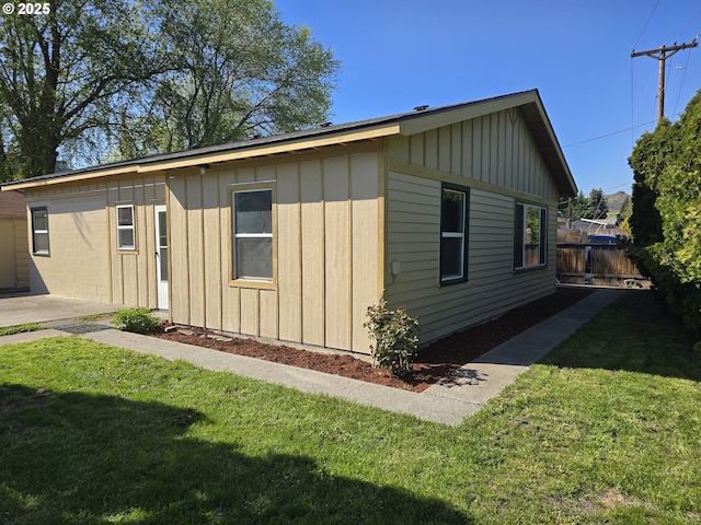 3208 W 7th St, The Dalles, OR 97058 - view of side of home featuring board and batten siding, fence, and a yard