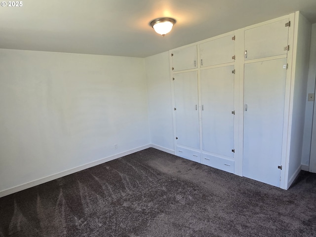 3208 W 7th St, The Dalles, OR 97058 - unfurnished bedroom with a closet, dark colored carpet, and baseboards