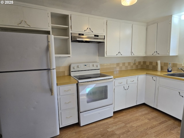 3208 W 7th St, The Dalles, OR 97058 - kitchen with white cabinets, under cabinet range hood, white appliances, and light wood finished floors