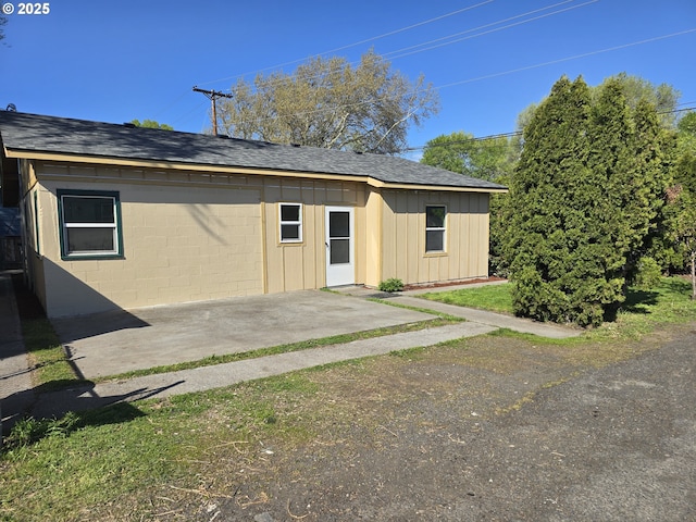3208 W 7th St, The Dalles, OR 97058 - exterior space with concrete block siding, a patio, and roof with shingles