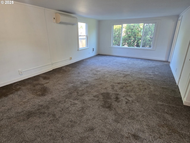 3208 W 7th St, The Dalles, OR 97058 - spare room featuring a wall mounted air conditioner, baseboards, and dark carpet